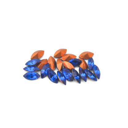 Navette shaped faceted Austrian crystal rhinestones in the color Capri Blue displayed on a white background.