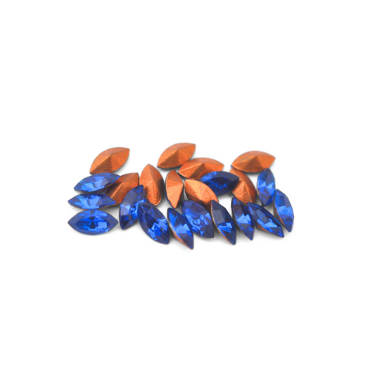 Navette shaped faceted Austrian crystal rhinestones in the color Capri Blue displayed on a white background.