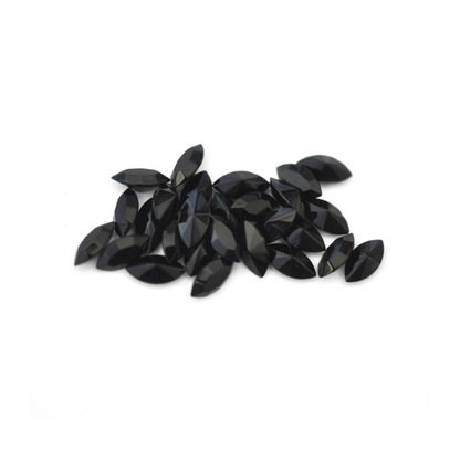 Navette shaped faceted Austrian crystal rhinestones in the color Jet displayed on a white background.