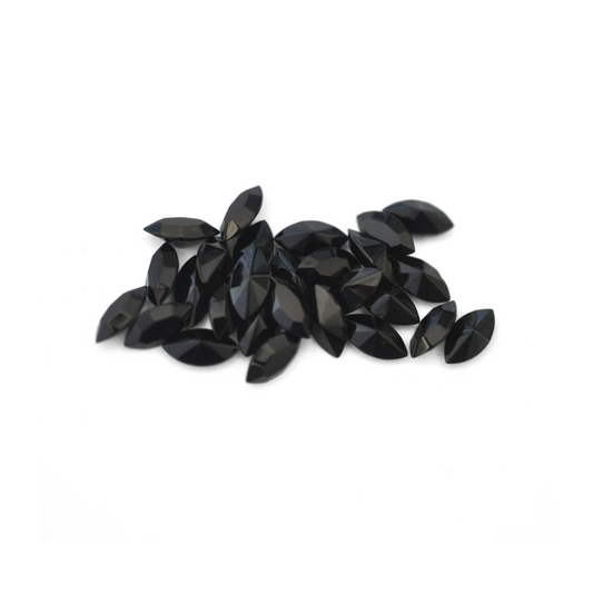 Navette shaped faceted Austrian crystal rhinestones in the color Jet displayed on a white background.