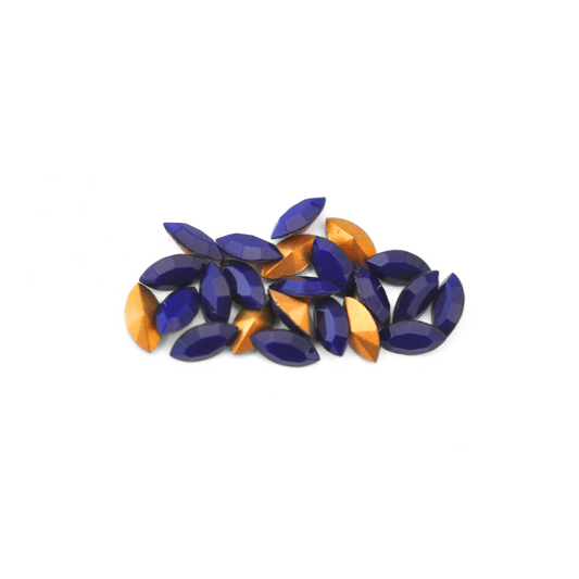 Navette shaped faceted Austrian crystal rhinestones in the color Navy Blue displayed on a white background.