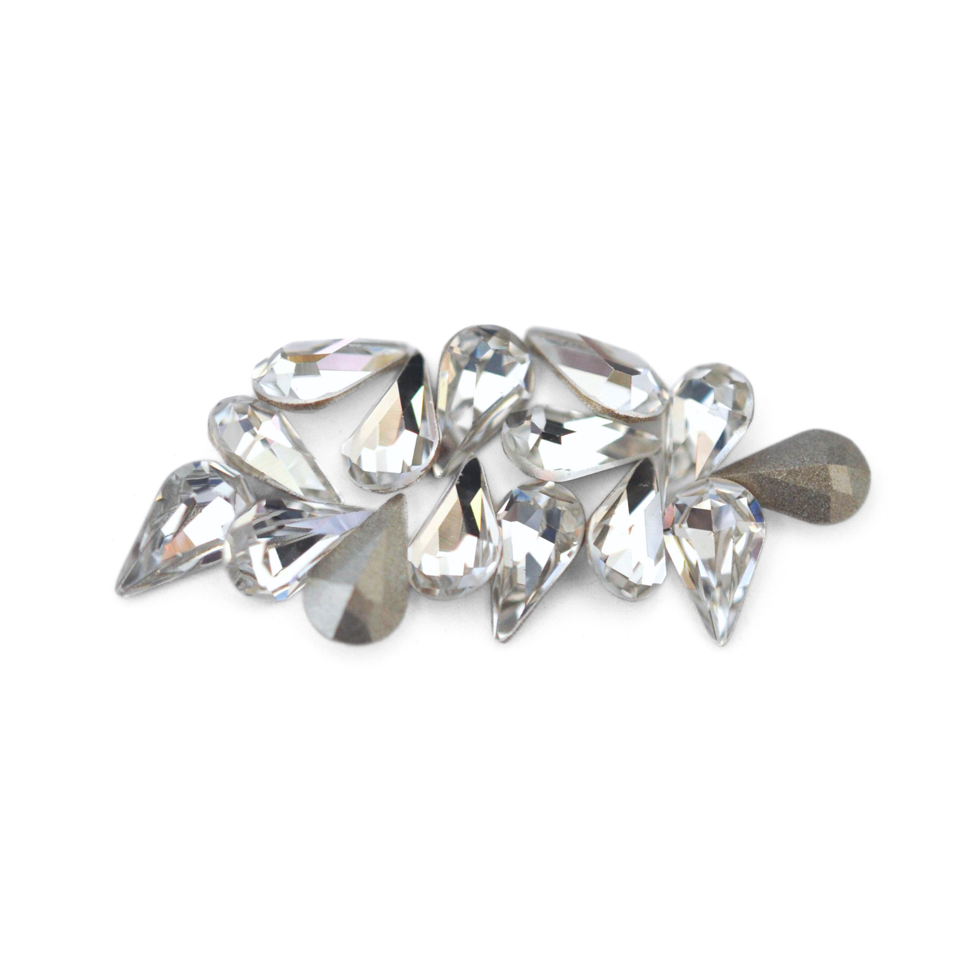 Pear shaped faceted Austrian crystal rhinestones in the color Crystal displayed on a white background. 