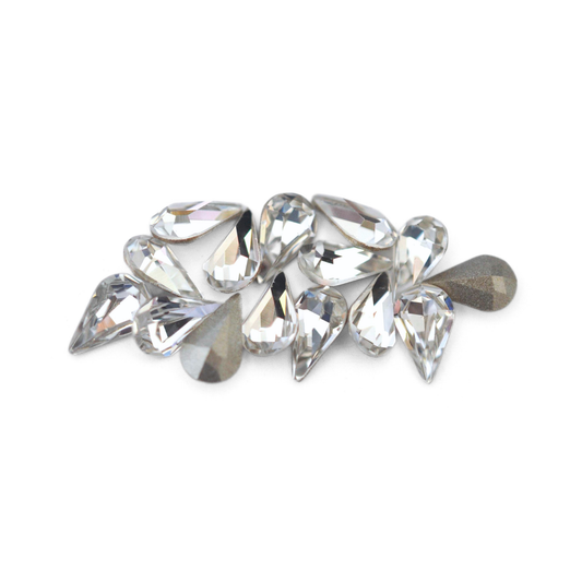 Pear shaped faceted Austrian crystal rhinestones in the color Crystal displayed on a white background. 