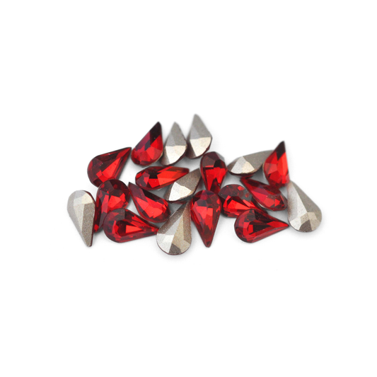 Pear shaped faceted Austrian crystal rhinestones in the color Siam displayed on a white background. 