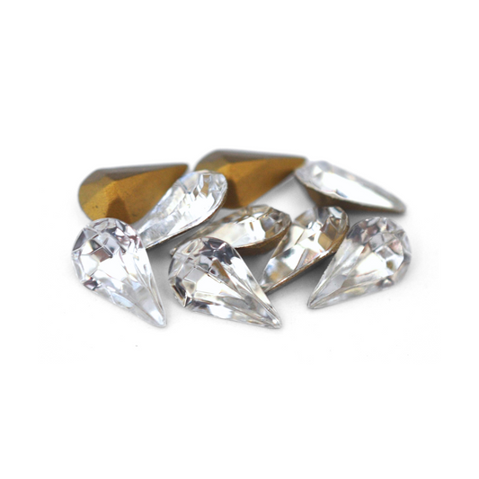 Pear shaped faceted Austrian crystal rhinestones in the color Crystal displayed on a white background. 