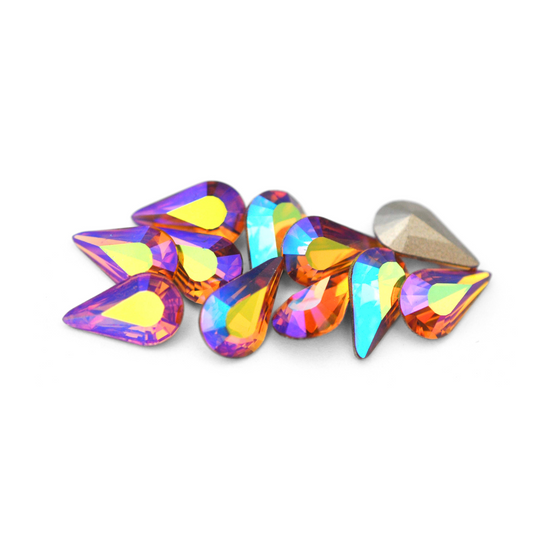 Pear shaped faceted Austrian crystal rhinestones in the color Topaz AB displayed on a white background. 