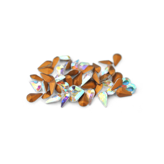 Pear shaped faceted Austrian crystal rhinestones in the color Crystal AB displayed on a white background. 