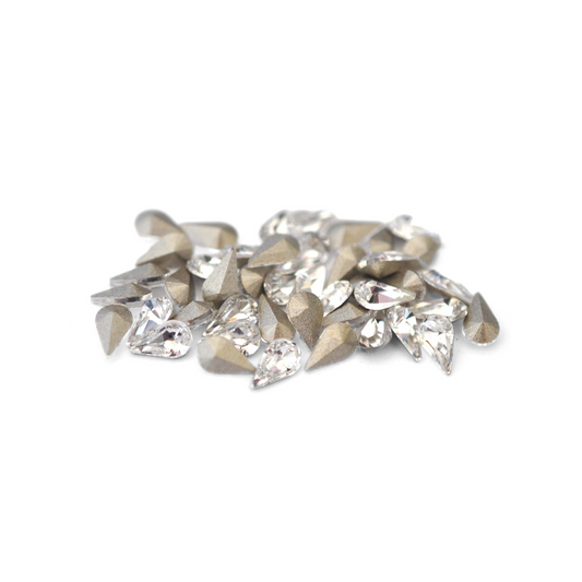 Pear shaped faceted Austrian crystal rhinestones in the color Crystal displayed on a white background. 