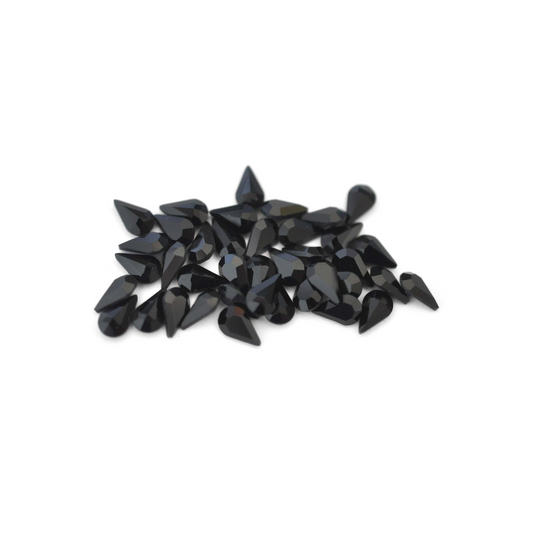Pear shaped faceted Austrian crystal rhinestones in the color Jet displayed on a white background. 