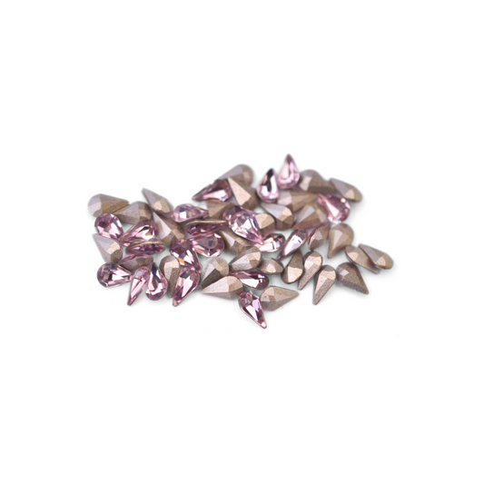 Pear shaped faceted Austrian crystal rhinestones in the color Light Amethyst displayed on a white background. 