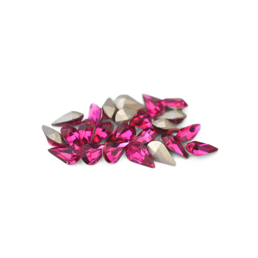Pear shaped faceted Austrian crystal rhinestones in the color Fuchsia displayed on a white background. 