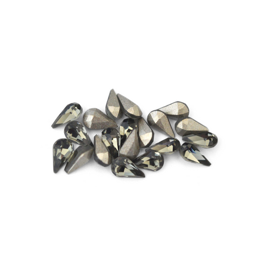 Pear shaped faceted Austrian crystal rhinestones in the color Black Diamond displayed on a white background. 