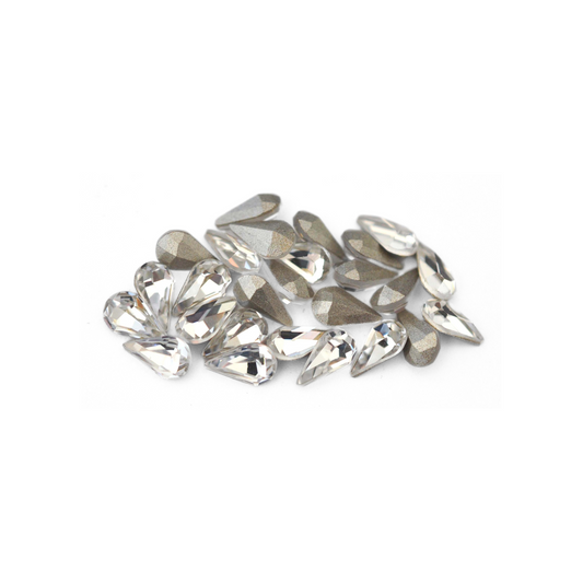 Pear shaped faceted Austrian crystal rhinestones in the color Crystal displayed on a white background. 