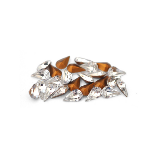 Pear shaped faceted Austrian crystal rhinestones in the color Crystal displayed on a white background. 