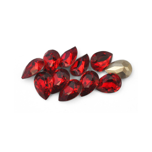 Pear shaped faceted Austrian crystal rhinestones in the color Siam displayed on a white background. 