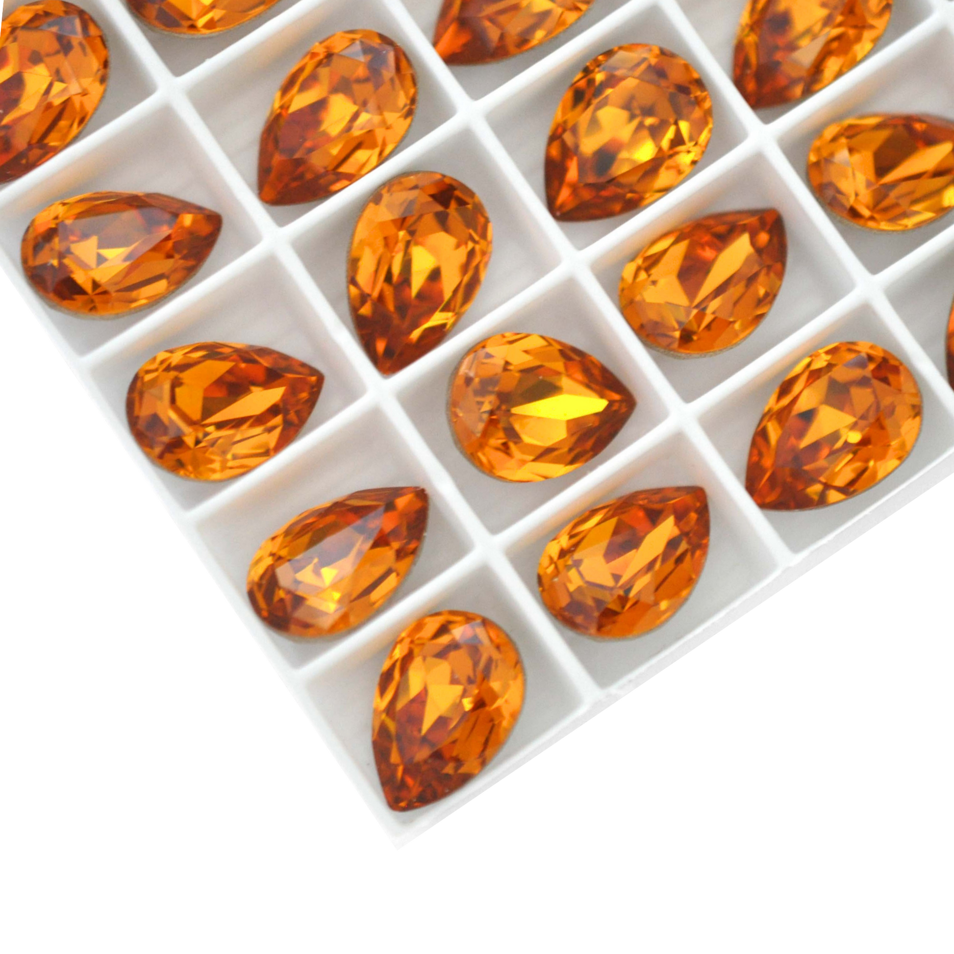 Pear shape faceted Austrian crystal rhinestones in the color Topaz displayed on a white background.