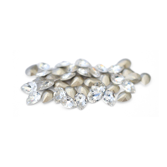 Pear shaped faceted Austrian crystal rhinestones in the color Crystal displayed on a white background. 