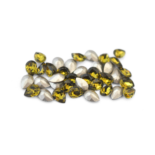 Pear shaped faceted Austrian crystal rhinestones in the color Khaki displayed on a white background. 