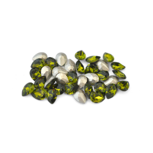 Pear shaped faceted Austrian crystal rhinestones in the color Olivine displayed on a white background. 