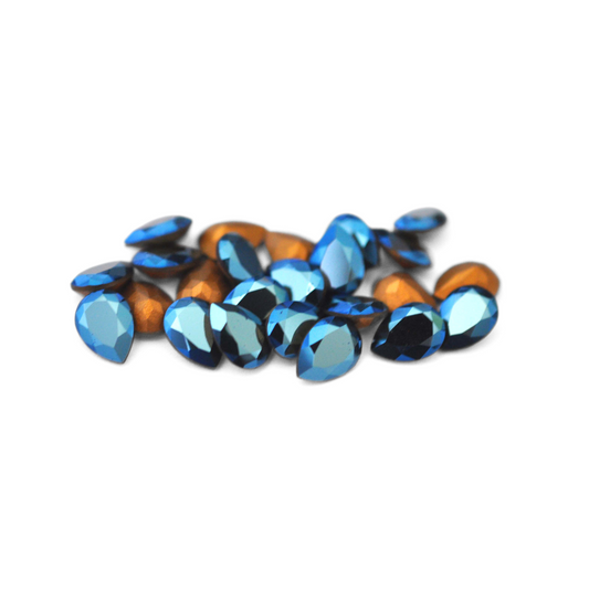 Pear shaped faceted Austrian crystal rhinestones in the color Metallic Blue displayed on a white background. 