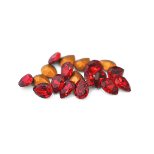 Pear shaped faceted Austrian crystal rhinestones in the color Siam displayed on a white background. 