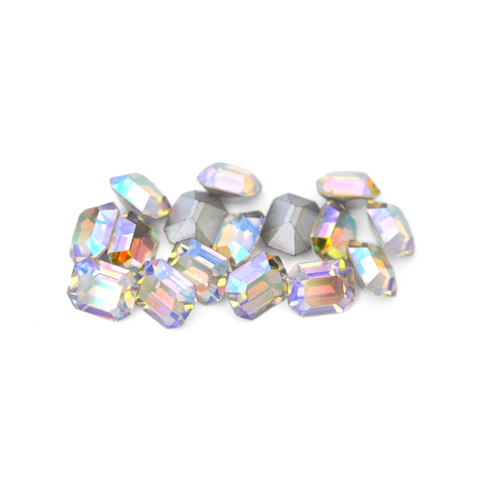 Octagon shaped faceted Austrian crystal rhinestones in the color Crystal AB displayed on a white background. 
