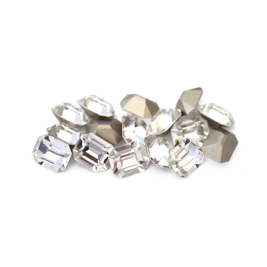 Octagon shaped faceted Austrian crystal rhinestones in the color Crystal displayed on a white background. 