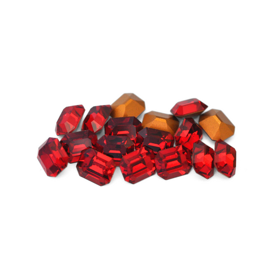 Octagon shaped faceted Austrian crystal rhinestones in the color Siam displayed on a white background. 