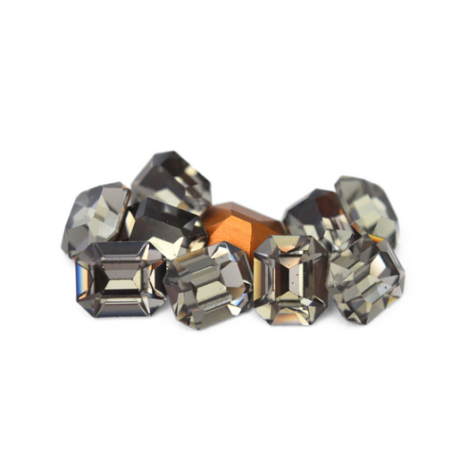 Octagon shaped faceted Austrian crystal rhinestones in the color Black Diamond displayed on a white background. 