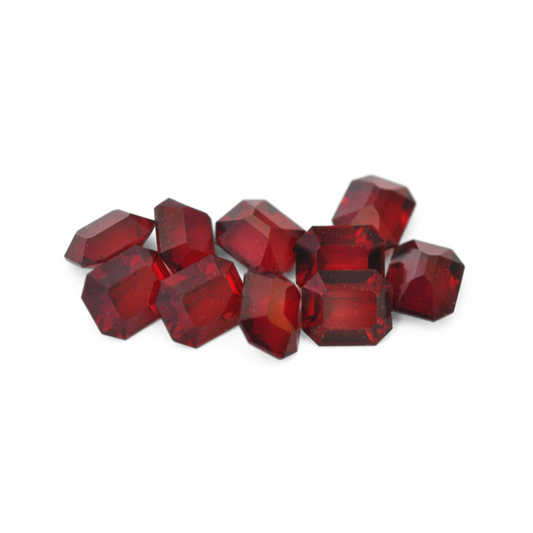 Octagon shaped faceted Austrian crystal rhinestones in the color Garnet Unfoiled displayed on a white background. 