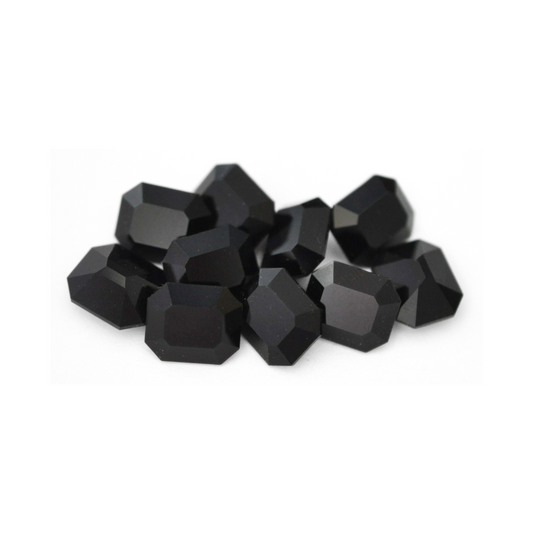 Octagon shaped faceted Austrian crystal rhinestones in the color Jet displayed on a white background. 