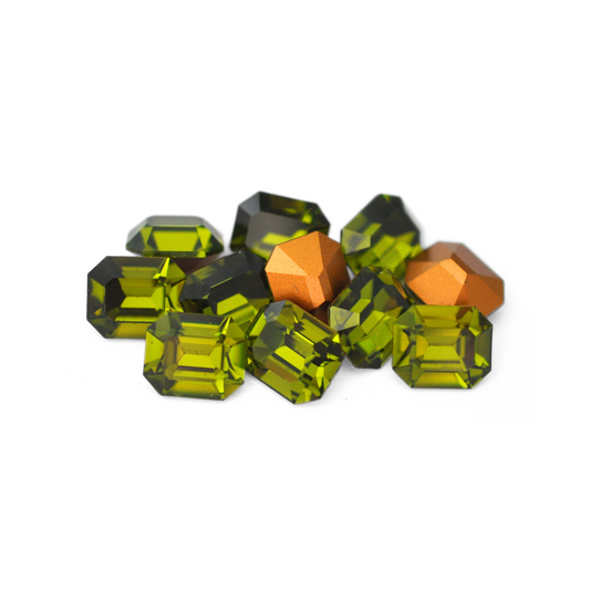 Octagon shaped faceted Austrian crystal rhinestones in the color Olivine displayed on a white background. 