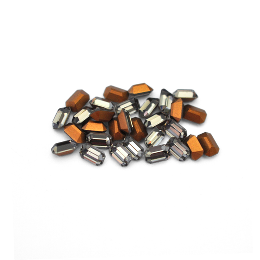Octagon shaped faceted Austrian crystal rhinestones in the color Black Diamond displayed on a white background. 