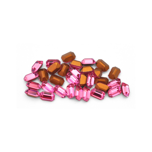Octagon shaped faceted Austrian crystal rhinestones in the color Rose displayed on a white background. 