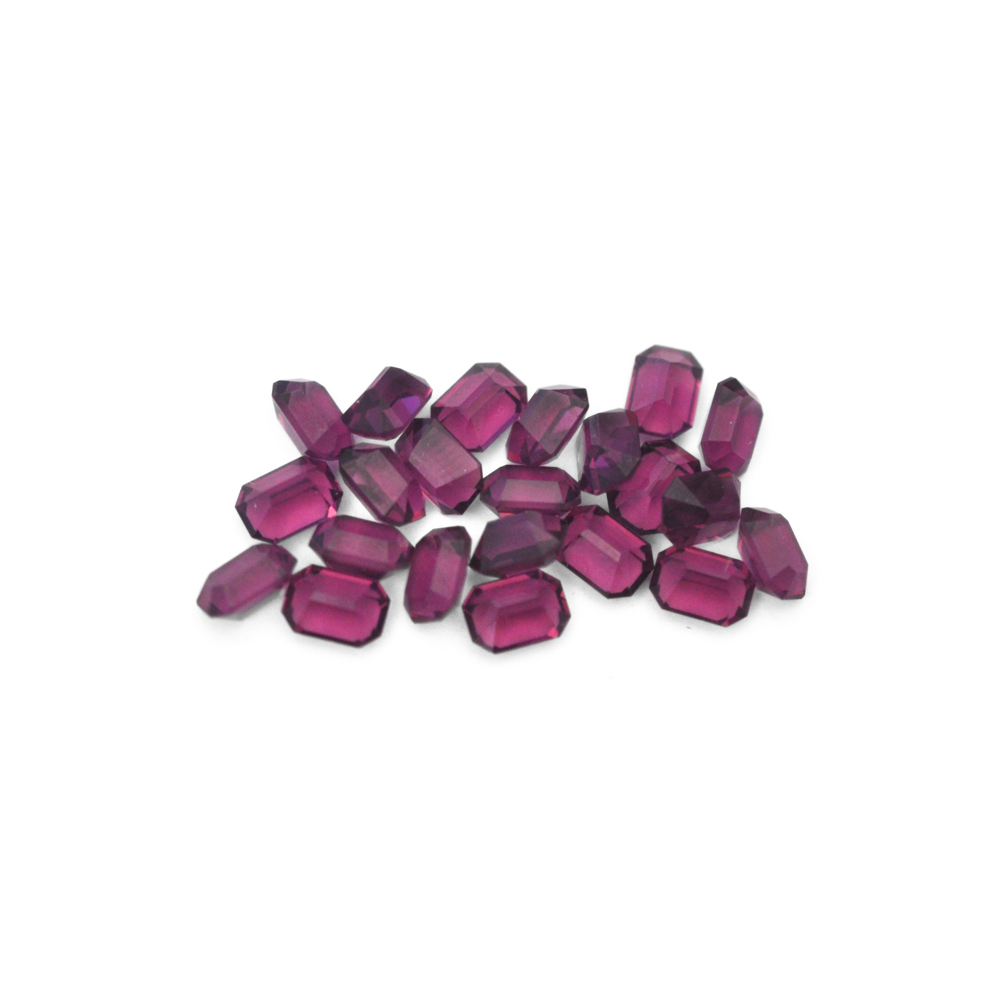 Octagon shaped faceted Austrian crystal rhinestones in the color Amethyst displayed on a white background. 