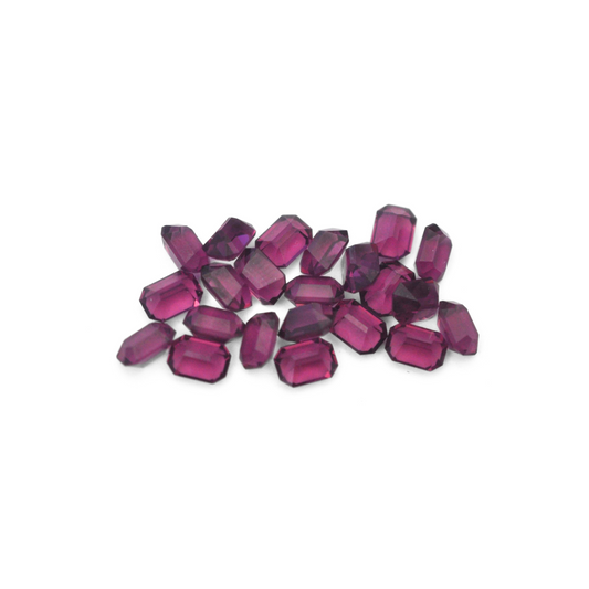 Octagon shaped faceted Austrian crystal rhinestones in the color Amethyst displayed on a white background. 