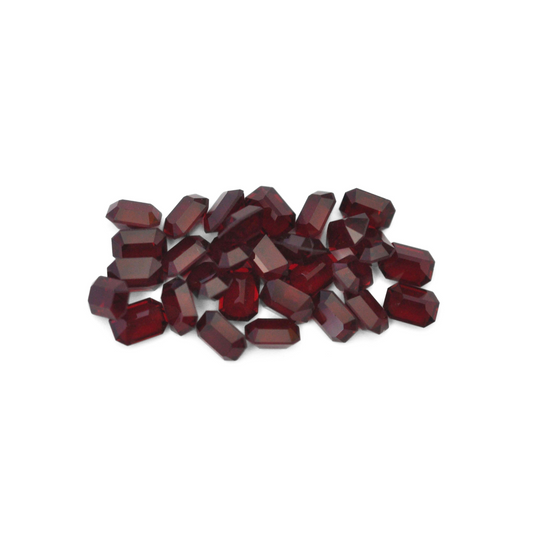 Octagon shaped faceted Austrian crystal rhinestones in the color Garnet displayed on a white background. 