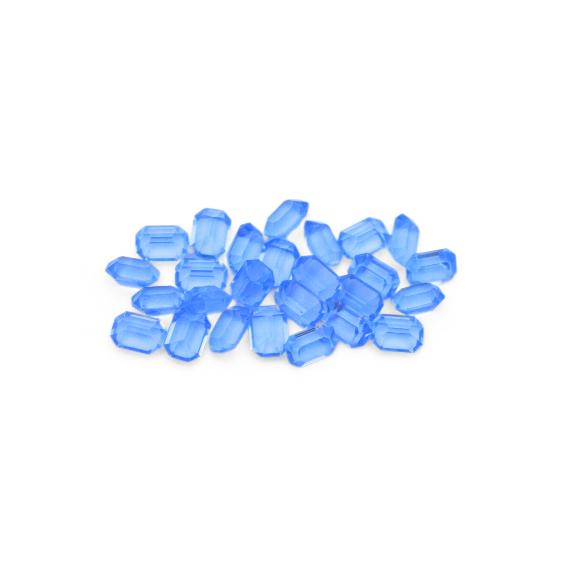 Octagon shaped faceted Austrian crystal rhinestones in the color Light Sapphire displayed on a white background. 