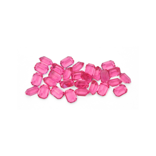Octagon shaped faceted Austrian crystal rhinestones in the color Rose displayed on a white background. 