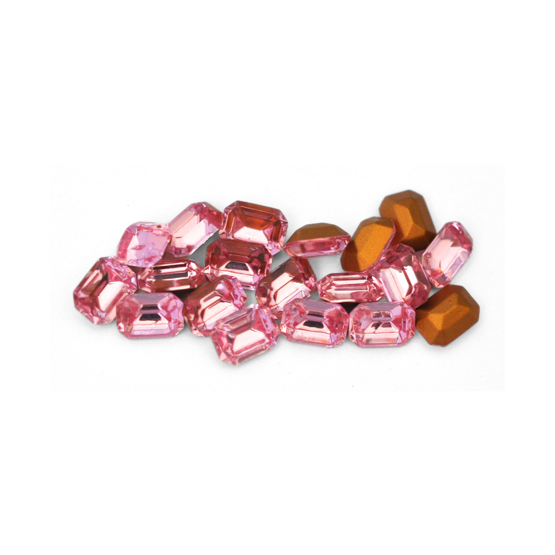 Octagon shaped faceted Austrian crystal rhinestones in the color Light Rose displayed on a white background. 