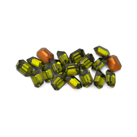 Octagon shaped faceted Austrian crystal rhinestones in the color Olivine displayed on a white background. 