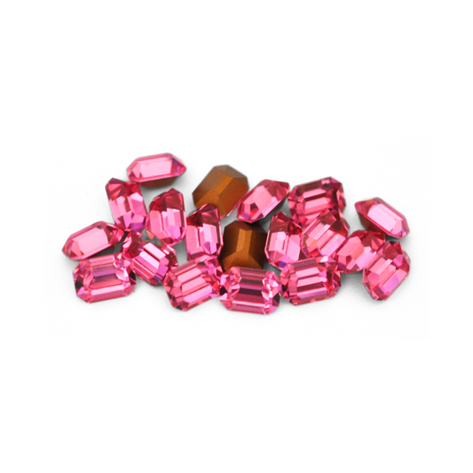 Octagon shaped faceted Austrian crystal rhinestones in the color Rose displayed on a white background. 