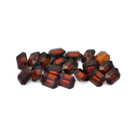Octagon shaped faceted Austrian crystal rhinestones in the color Smoked Topaz displayed on a white background. 