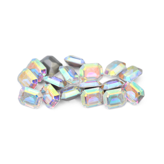 Octagon shaped faceted Austrian crystal rhinestones in the color Crystal AB displayed on a white background. 