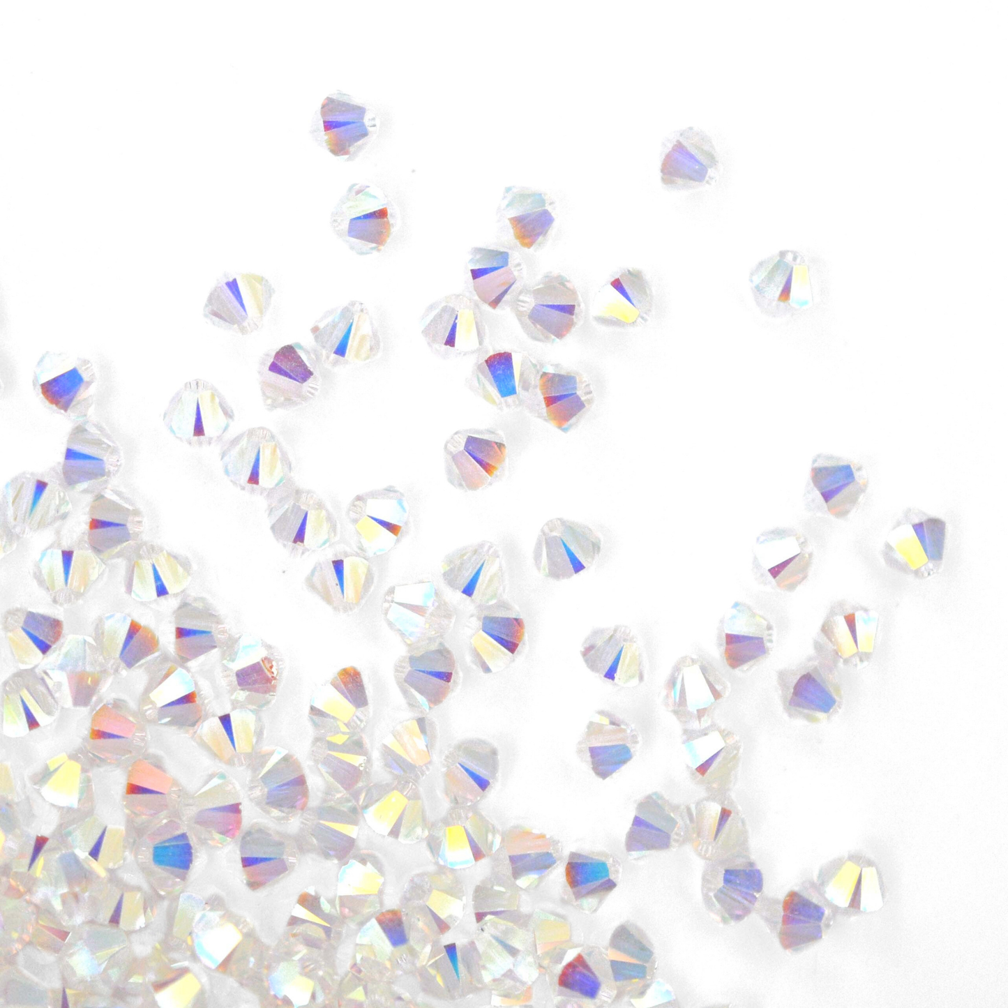 Austrian crystal 5328 bicone beads in the color Crystal Transmission 2X spilling out onto a white background. 