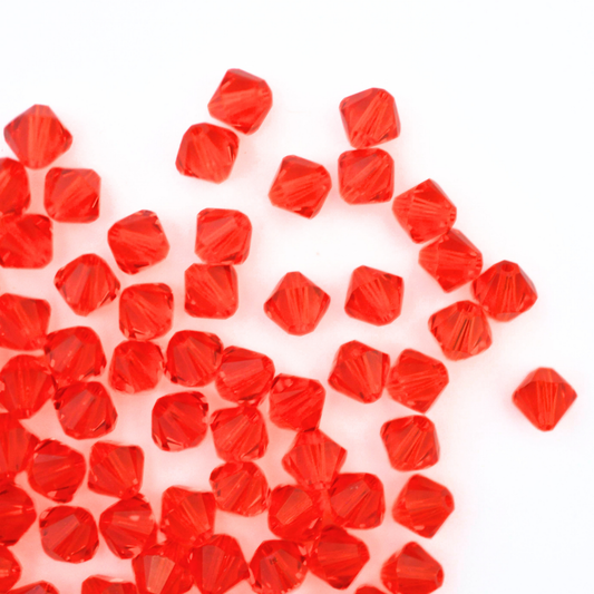Austrian crystal 5328 bicone beads in the color Hyacinth spilling out onto a white background. 