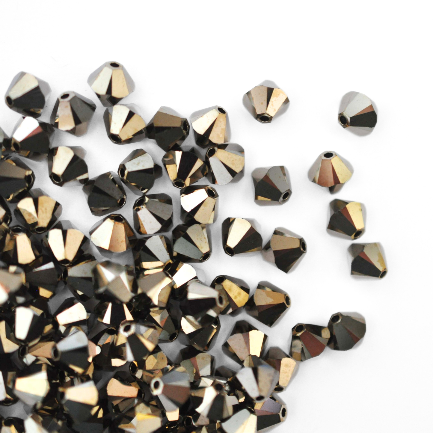 Austrian crystal 5328 bicone beads in the color Metallic Light Gold 2X spilling out onto a white background.