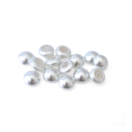 Round Austrian Crystal Glass Pearl Cabochons in the color Moonlight displayed on a white background