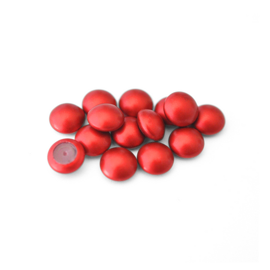 Round Austrian Crystal Glass Pearl Cabochons in the color Iridescent Rouge displayed on a white background