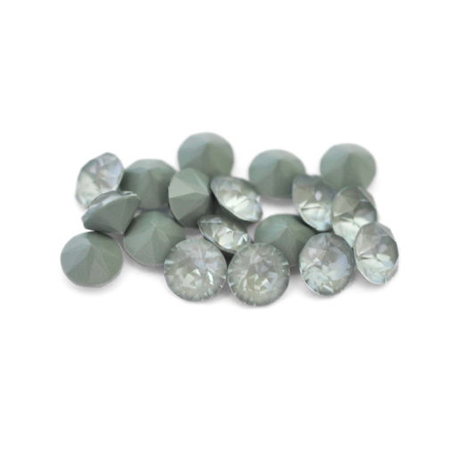 Round faceted Austrian crystal rhinestones in the color Agave Ignite displayed on a white background